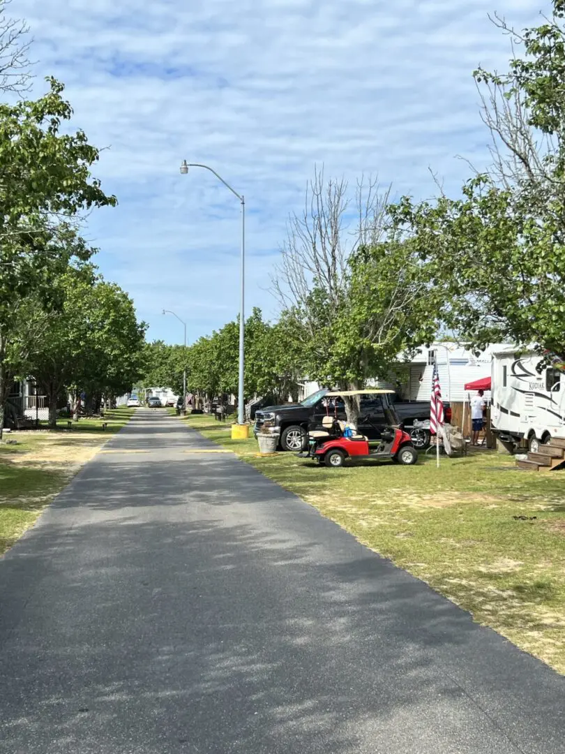 A street with many cars parked on the side of it